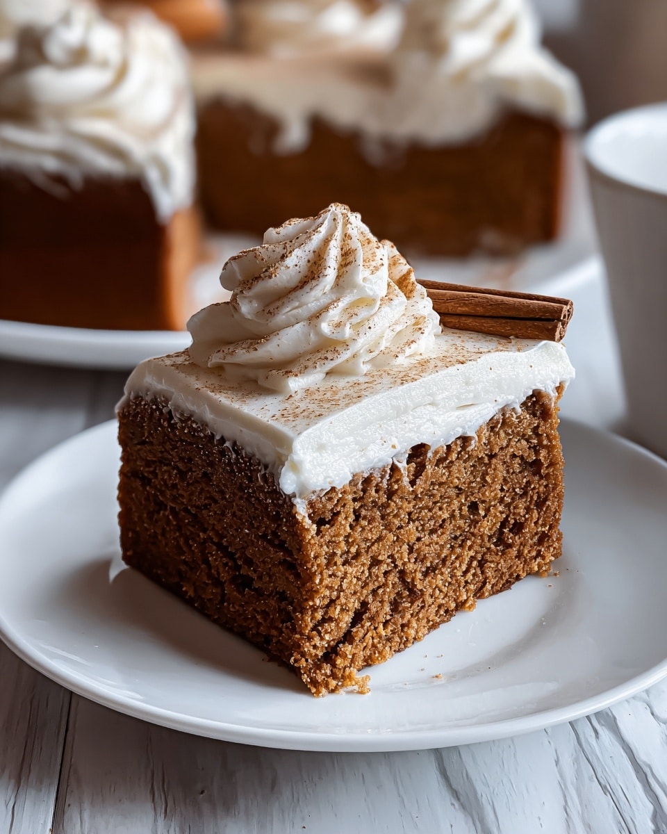 A close-up image of a square gingerbread cake piece placed on a white plate with a white marbled surface underneath, featuring two distinct layers: the bottom is a thick, dense, dark brown gingerbread cake with a slightly coarse texture, and the top is a thick, smooth, and creamy white frosting layer evenly spread. On top of the frosting, there is a swirl of piped cream in a soft peak form, lightly sprinkled with brown spice powder, adding texture and color contrast. The background shows blurred warm brown tones resembling cinnamon sticks. photo taken with an iphone --ar 4:5 --v 7