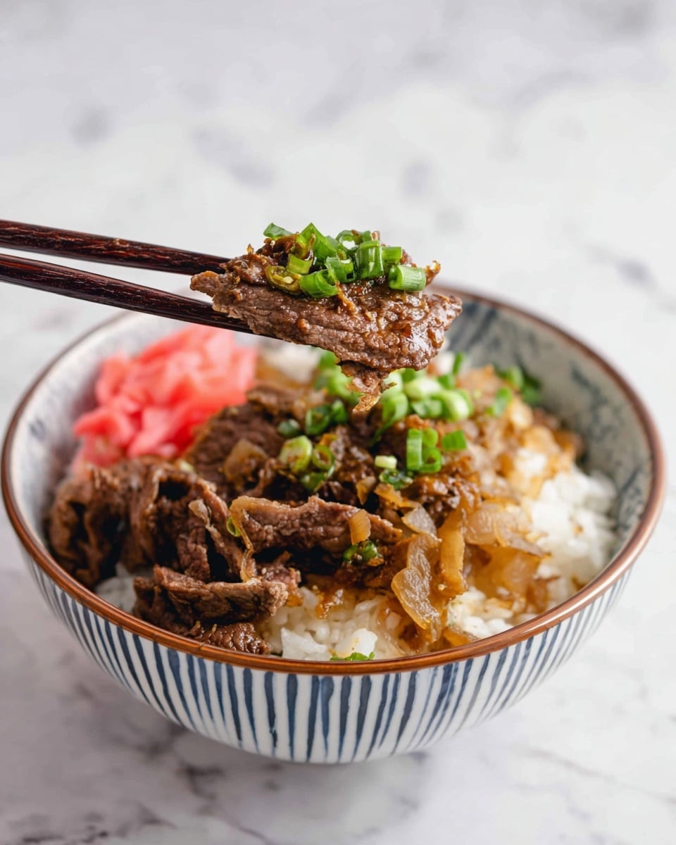 A bowl with three main layers is shown: the bottom layer is white rice with a soft texture, the middle layer consists of cooked brown beef slices mixed with caramelized light brown onions, and the top layer has small bright green chopped scallions and a few pink pickled ginger pieces. A pair of dark brown chopsticks hold a piece of beef topped with a green scallion above the bowl. The bowl is white with blue vertical stripes on the inside and a brown rim. The background and surface have a white marbled texture. Photo taken with an iphone --ar 4:5 --v 7